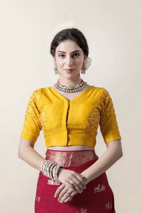 A clear front view of the Vanya Sarees readymade designer blouse in yellow, highlighting the sparkling hand-scattered embellishments.