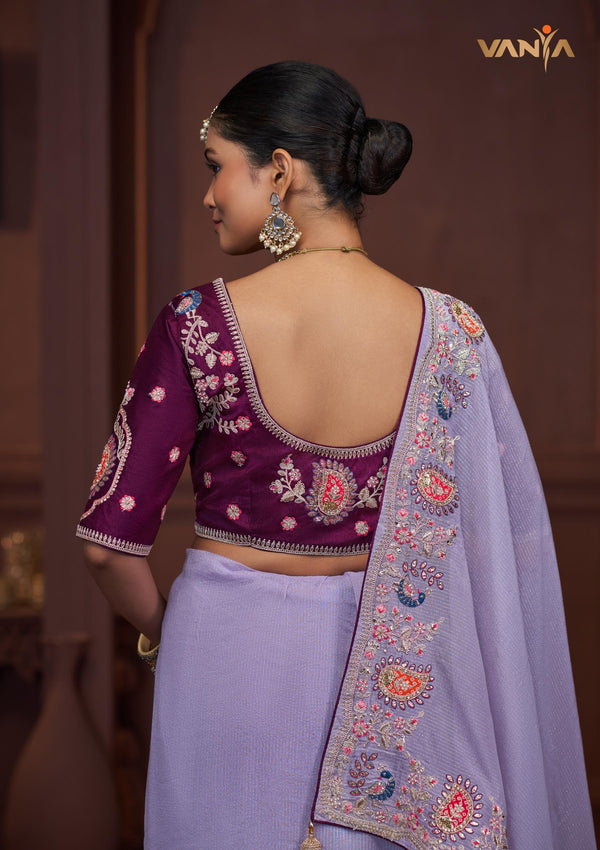 The elegant back view of the Vanya Sarees ensemble, showcasing the heavy embroidery on the pallu and the designer back of the plum blouse.