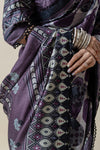 Close-up detail of the Vanya saree's black tassel on the pallu, the sleeve's mirror work, and the model's stacked white bangles.