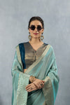 A stylish close-up of the model in sunglasses, wearing the Vanya Sarees aqua blue tissue saree and designer blouse.
