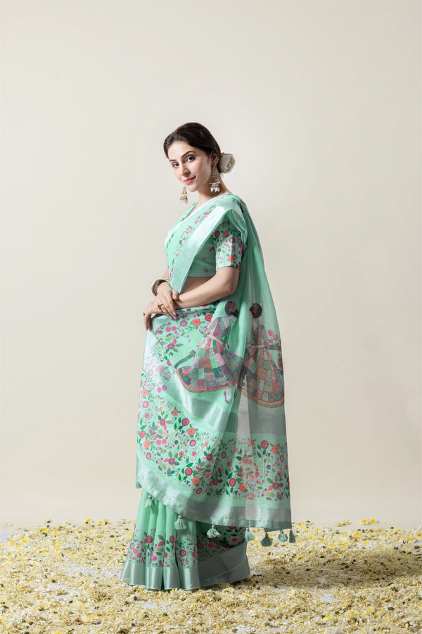 A stylish side profile of the model wearing the Vanya Sarees mint green printed saree, showing the complete festive ensemble.