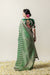 A full back view of the model in the Vanya Sarees ensemble, displaying the woven zari pallu and the stunning Gaja Lakshmi embroidery on the blouse.
