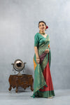 An elegant pose of the model highlighting the rich, green Banarasi zari border on the Vanya Sarees multi-color Bandhani saree.