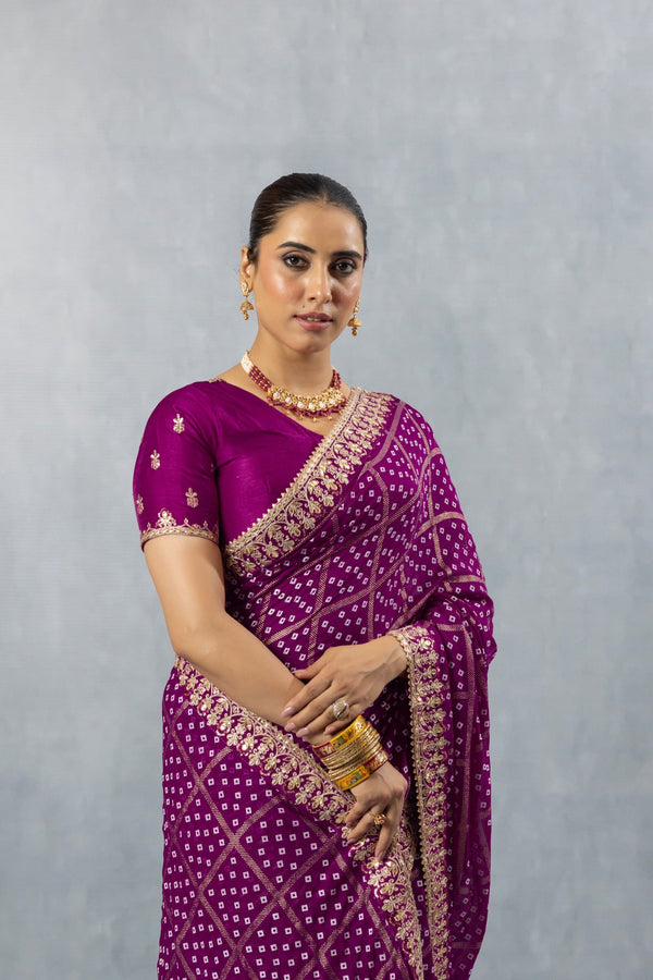 A close-up of the model wearing the Vanya Sarees purple Bandhani saree, highlighting the exquisite hand-embroidered zardozi border.