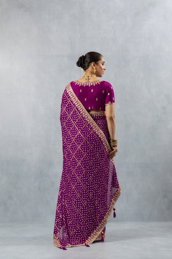 A full back view of the model in the Vanya Sarees purple Bandhani saree, showcasing the drape of the heavy embroidered pallu.