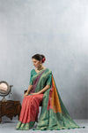 Model seated gracefully in the Vanya Sarees multi-color Bandhani silk saree, showcasing the full festive ensemble.