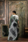 A full back view of the model displaying the bold, tropical Batik print on the pallu of the Vanya Sarees linen saree.