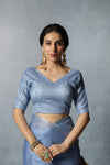 A clear front view of the Vanya Sarees readymade designer blouse in blue, showing the wide V-neck and shimmering fabric.