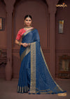 A full-length view of the model in Vanya Sarees' elegant royal blue georgette saree with a contrasting red Bandhani print blouse.