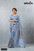 A full-length view of the model in Vanya Sarees' artistic periwinkle blue linen silk saree with a modern floral print.