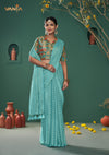 An elegant standing pose of the model showcasing the complete designer look of the Vanya Sarees aqua blue saree and Patola print blouse.