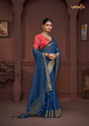 An graceful standing pose of the model showcasing the complete designer look of the Vanya Sarees blue saree and red Bandhani print blouse.