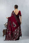 Vanya Sarees: Back view of the maroon saree detailing the low V-neck back of the stitched blouse and the stunning metallic pallu drape.