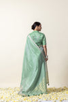 A full back view of the model in the Vanya Sarees ensemble, displaying the complete look with the embroidered blouse back and woven pallu.