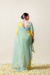 Full back view of the model, displaying the sheer sea green Gota Patti pallu and the deep V-back of the blouse from Vanya Sarees.