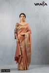 A full-length view of the model in Vanya Sarees' luxurious copper rose Katan Banarasi silk saree with a designer bell sleeve blouse.