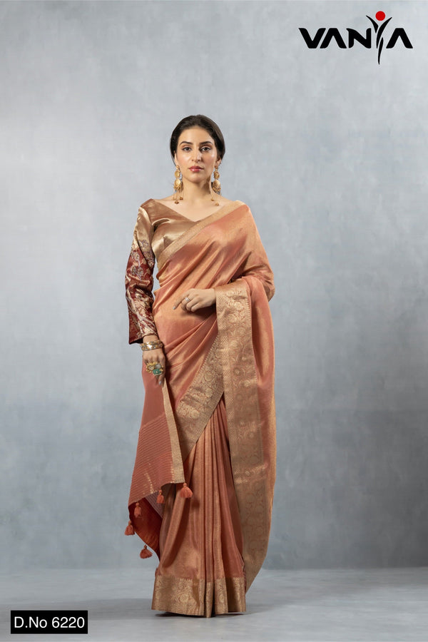 A full-length view of the model in Vanya Sarees' luxurious copper rose Katan Banarasi silk saree with a designer bell sleeve blouse.