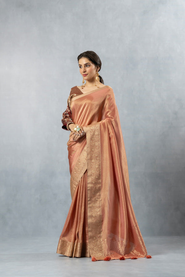 An elegant standing pose of the model in the Vanya Sarees copper rose Banarasi silk saree, perfect for a wedding or reception.