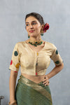 A clear front view of the Vanya Sarees readymade designer blouse in cream, showing the V-neck and colorful appliqué on the sleeve.