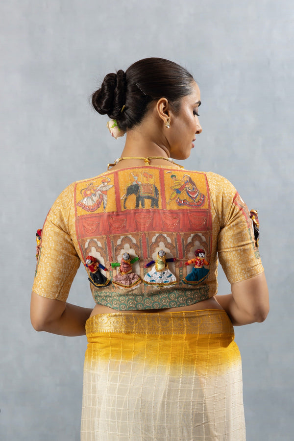 The extraordinary back of the designer blouse from Vanya Sarees, featuring a folk art mural and unique, handcrafted 3D Kathputli (puppet) dolls.