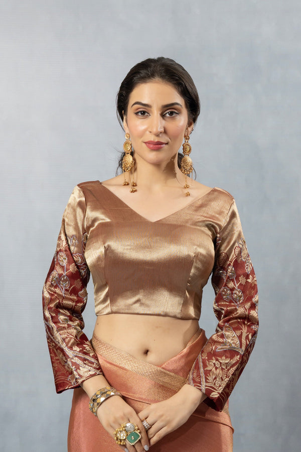 A clear front view of the unique designer blouse from Vanya Sarees, showing the copper body and the dramatic maroon and gold brocade bell sleeves.
