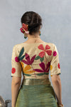 The stunning statement back of the designer blouse from Vanya Sarees, featuring a large, multi-color abstract floral appliqué.