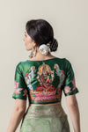 The magnificent hand-embroidered Gaja Lakshmi motif on the back of the emerald green designer blouse from Vanya Sarees.