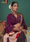 A close-up of the unique designer blouse from Vanya Sarees, showing the high collar, brocade details, and embroidered bell sleeves.