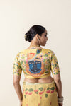 Close-up of the designer blouse back from Vanya Sarees, featuring a detailed Pichwai portrait of Lord Krishna.