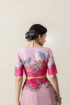 The artistic statement back of the designer blouse from Vanya Sarees, featuring a colorful print of birds on floral branches.