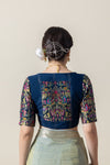 The stunning brocade back of the navy blue designer blouse from Vanya Sarees, featuring woven peacock and elephant motifs.