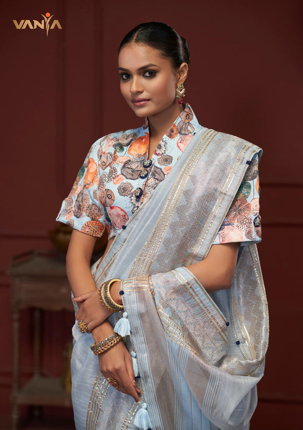 A close-up of the Vanya Sarees' ensemble, detailing the artistic print on the high collar neck blouse and the handcrafted tassels on the pallu.