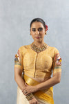 A clear front view of the Vanya Sarees readymade designer blouse, showing the V-neck and printed puppet motifs on the sleeves.