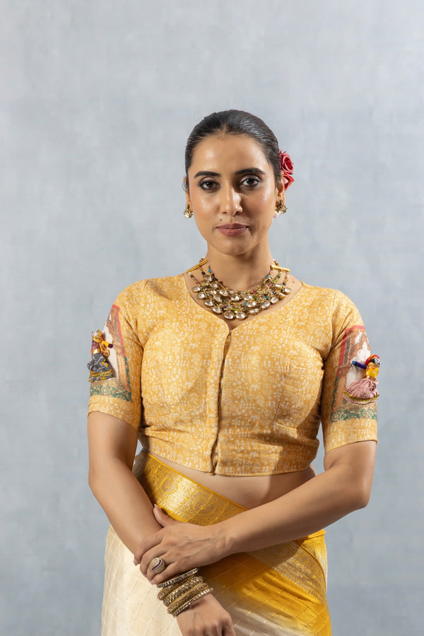 A clear front view of the Vanya Sarees readymade designer blouse, showing the V-neck and printed puppet motifs on the sleeves.