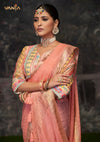 A beautiful close-up of the model in a Vanya Sarees saree, highlighting the unique print and embroidery on the designer blouse sleeve.