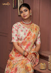 A beautiful seated portrait of the model in a Vanya Sarees organza saree, highlighting the heavy floral embroidery on the border and the printed designer blouse.