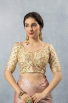 A clear front view of the Vanya Sarees heavy, hand-embroidered designer blouse in cream, featuring multi-color floral resham work and a sweetheart neckline.