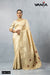 Vanya full-length view of the model standing, showcasing the entire Champagne Gold Zari saree and the embroidered blouse.