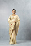 Vanya full-length front pose of the Champagne Gold saree, showcasing the luxurious shine and the heavy border detailing.