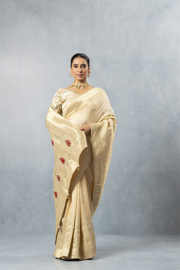 Vanya full-length front pose of the Champagne Gold saree, showcasing the luxurious shine and the heavy border detailing.