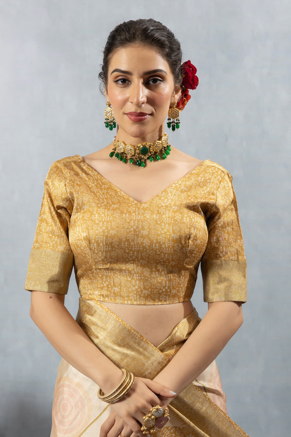 A clear front view of the Vanya Sarees readymade designer blouse in gold brocade, showing the V-neck and rich texture.