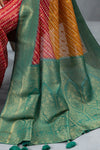 A detailed close-up of the pallu of the Vanya Sarees saree, showing the rich green and gold Banarasi zari weave.