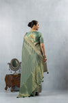 A full back view of the model in the Vanya Sarees ensemble, displaying the grand woven pallu and the embroidered designer blouse.