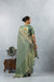 A full back view of the model in the Vanya Sarees ensemble, displaying the grand woven pallu and the embroidered designer blouse.