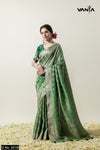 A full-length view of the model in Vanya Sarees' regal green and gold woven Banarasi silk saree with a designer blouse.