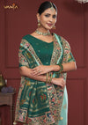 A close-up of the model wearing the Vanya Sarees green bridal saree, highlighting the rich embroidery on the pallu and designer blouse.
