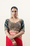 A clear front view of the Vanya Sarees heavy, hand-embroidered designer blouse in bottle green, featuring a sweetheart neckline and intricate zardozi work.
