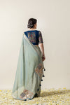 A full back view of the model in the Vanya Sarees ensemble, displaying the elegant drape of the linen silk pallu over the brocade blouse.
