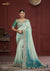 A full-length view of the model in Vanya Sarees' magnificent green ombre saree with a heavy, multi-color embroidered border.