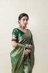 A close-up of the model wearing the Vanya Sarees green silk saree, highlighting the rich texture and the embroidered designer blouse.